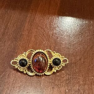 Elegant Gold and Red Brooch